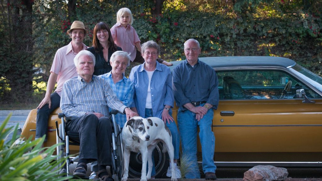 Multi-generational family with a large dog.